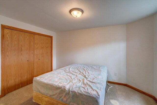 968 Pine St, Sun Prairie, WI 53590 - bedroom with baseboards, carpet floors, and a closet