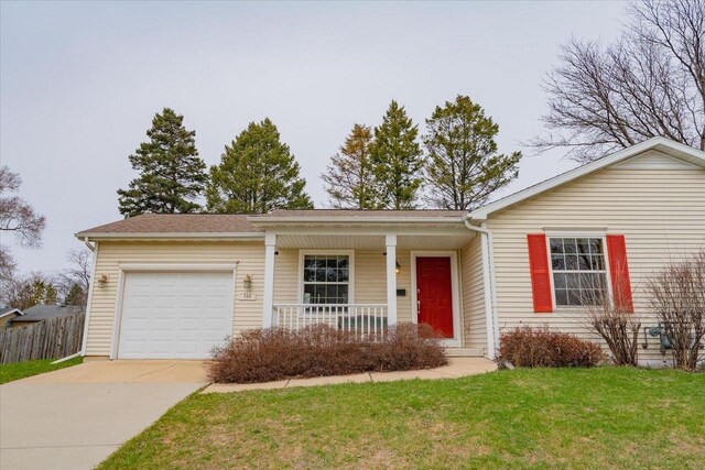 968 Pine St, Sun Prairie, WI 53590 - ranch-style house with fence, an attached garage, concrete driveway, a front yard, and a porch