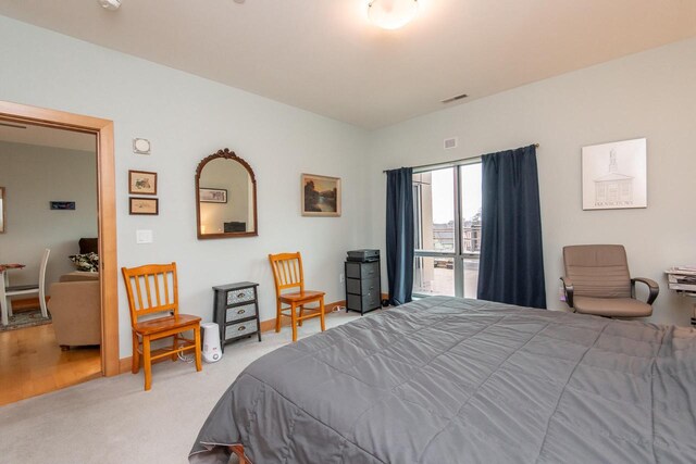 1550 E Royall Pl Unit 410, Milwaukee, WI 53202 - bedroom featuring baseboards, visible vents, and carpet
