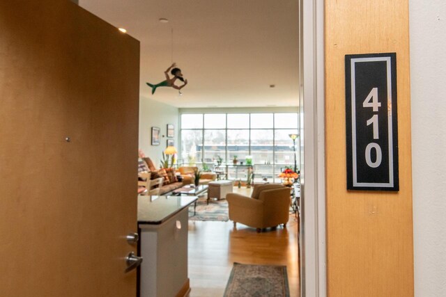 1550 E Royall Pl Unit 410, Milwaukee, WI 53202 - hallway with floor to ceiling windows and wood finished floors