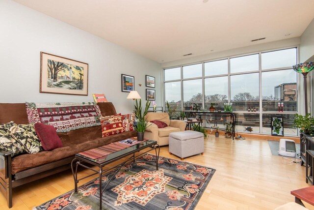 1550 E Royall Pl Unit 410, Milwaukee, WI 53202 - living room featuring expansive windows, visible vents, and wood finished floors