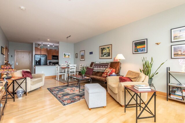 1550 E Royall Pl Unit 410, Milwaukee, WI 53202 - living room with rail lighting, baseboards, and light wood finished floors