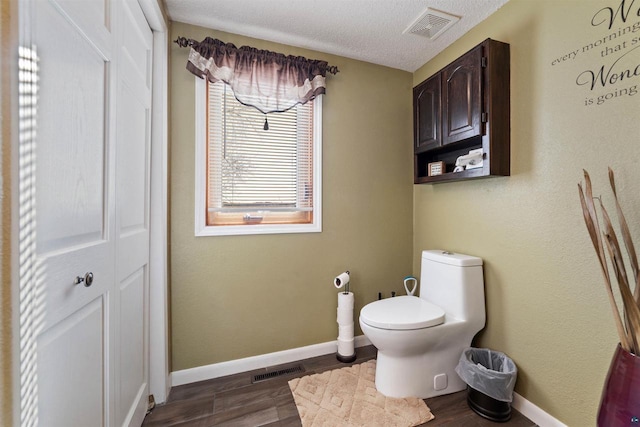 4463 E Singkofer, Superior, WI 54880 - bathroom with wood finished floors, baseboards, toilet, and a textured ceiling
