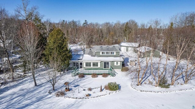 4463 E Singkofer, Superior, WI 54880 - snow covered property featuring a deck and a forest view