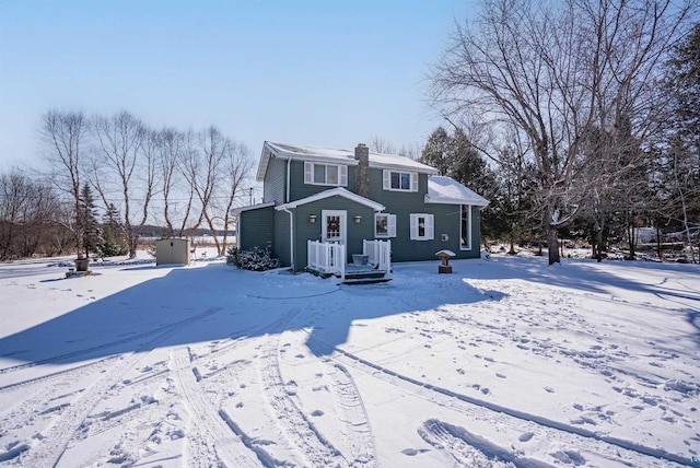 4463 E Singkofer, Superior, WI 54880 - view of snowy exterior with a chimney and cooling unit