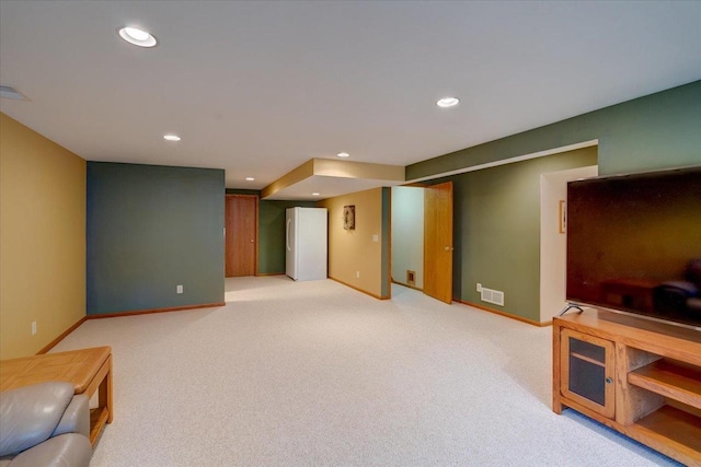 finished basement with recessed lighting, visible vents, and light colored carpet