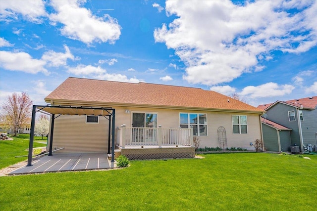 rear view of property with a patio, a lawn, a deck, and cooling unit