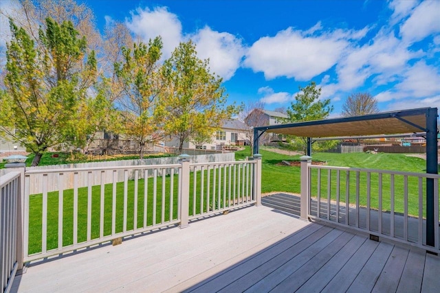 wooden terrace with a lawn and fence