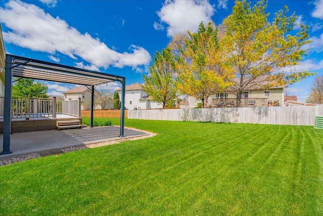 view of yard featuring a patio, fence, and a wooden deck
