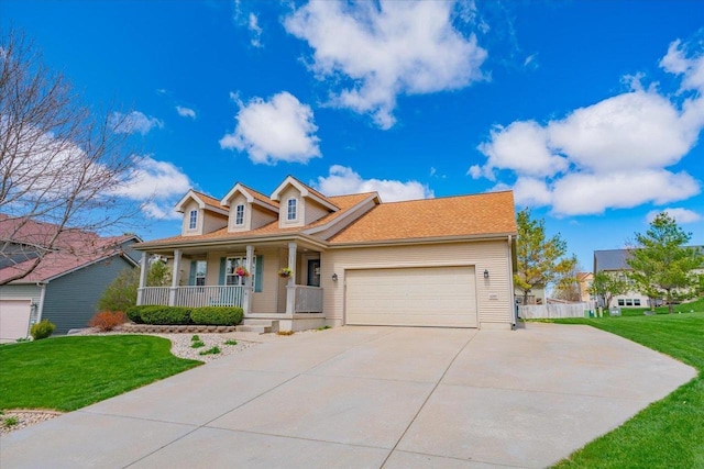 view of front of house with covered porch, concrete driveway, a front yard, and a garage