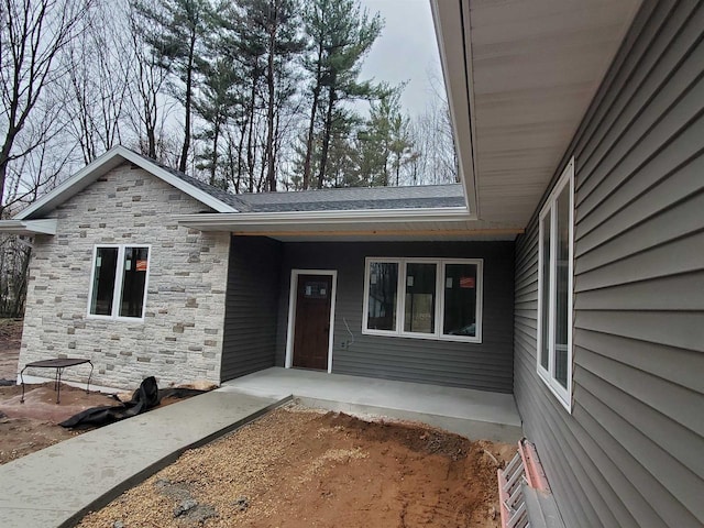 133 Thomas Ave, Shawano, WI 54166 - property entrance featuring stone siding and covered porch