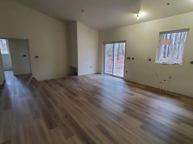 133 Thomas Ave, Shawano, WI 54166 - unfurnished living room with vaulted ceiling and wood finished floors