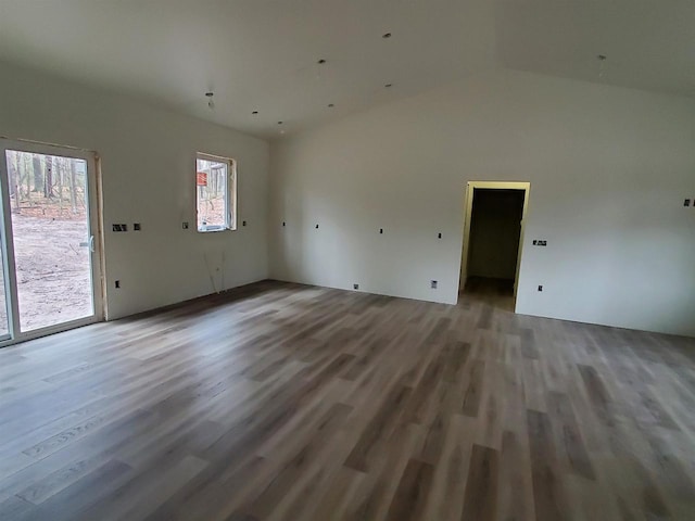 133 Thomas Ave, Shawano, WI 54166 - unfurnished living room with vaulted ceiling and wood finished floors