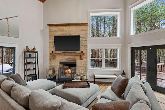W5430 Southview Dr, Necedah, WI 54646 - living area with plenty of natural light, wood finished floors, a high ceiling, and a fireplace