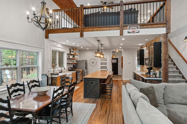 W5430 Southview Dr, Necedah, WI 54646 - dining area with stairs, a chandelier, light wood-type flooring, a towering ceiling, and recessed lighting
