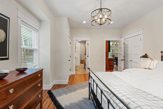 W5430 Southview Dr, Necedah, WI 54646 - bedroom featuring recessed lighting, wood finished floors, a closet, baseboards, and a notable chandelier
