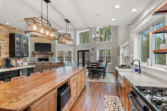 W5430 Southview Dr, Necedah, WI 54646 - kitchen with hardwood / wood-style floors, plenty of natural light, a fireplace, and butcher block countertops