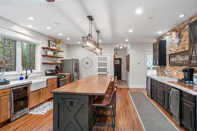 W5430 Southview Dr, Necedah, WI 54646 - kitchen with recessed lighting, beverage cooler, stainless steel appliances, a sink, and a kitchen island