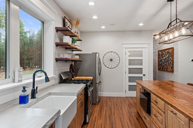 W5430 Southview Dr, Necedah, WI 54646 - kitchen with recessed lighting, stainless steel gas stove, open shelves, a sink, and wood counters