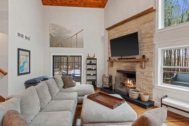 W5430 Southview Dr, Necedah, WI 54646 - living area with high vaulted ceiling, plenty of natural light, visible vents, and a fireplace