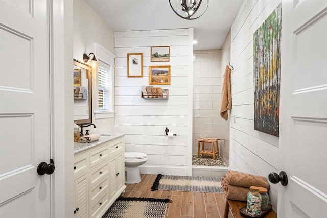 W5430 Southview Dr, Necedah, WI 54646 - full bathroom featuring wood finished floors, toilet, vanity, and a walk in shower