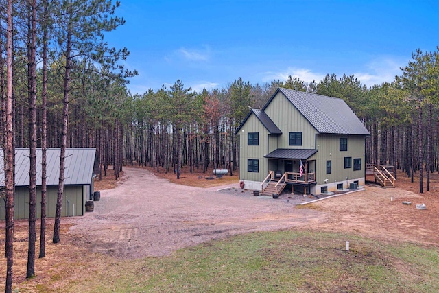 W5430 Southview Dr, Necedah, WI 54646 - back of house featuring driveway, a standing seam roof, and metal roof