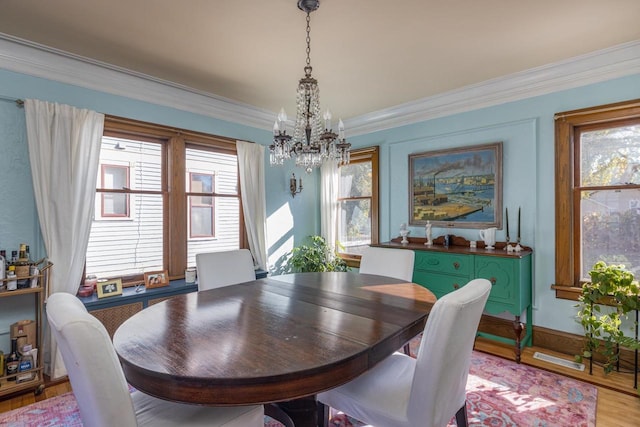 1337 Washington Ave, Oshkosh, WI 54901 - dining area featuring a chandelier, crown molding, and light wood finished floors