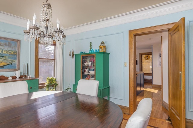 1337 Washington Ave, Oshkosh, WI 54901 - dining space with wood finished floors, a chandelier, and crown molding