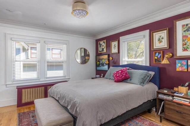 1337 Washington Ave, Oshkosh, WI 54901 - bedroom with radiator, wood finished floors, baseboards, and ornamental molding