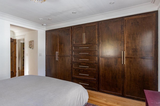 1337 Washington Ave, Oshkosh, WI 54901 - bedroom featuring a closet, crown molding, and light wood-style floors