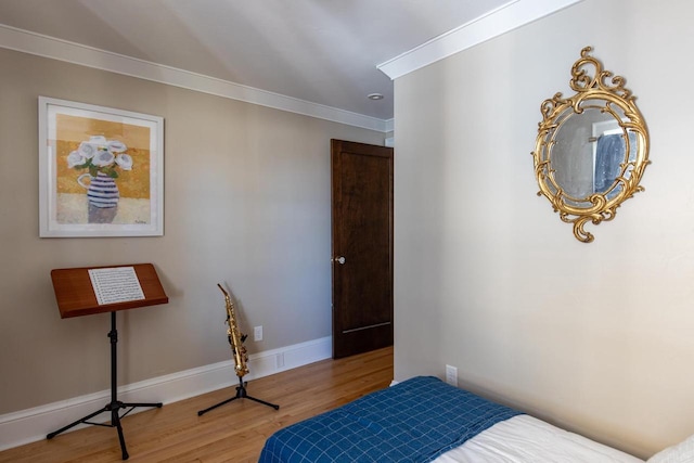 1337 Washington Ave, Oshkosh, WI 54901 - bedroom with crown molding, baseboards, and wood finished floors