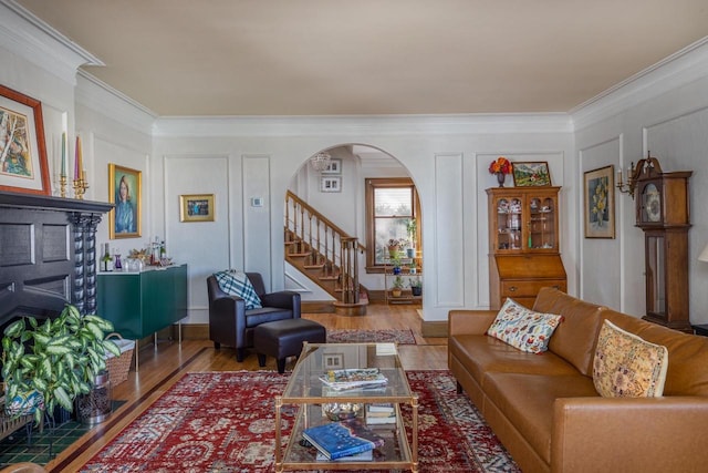 1337 Washington Ave, Oshkosh, WI 54901 - living area featuring stairway, arched walkways, ornamental molding, and a decorative wall
