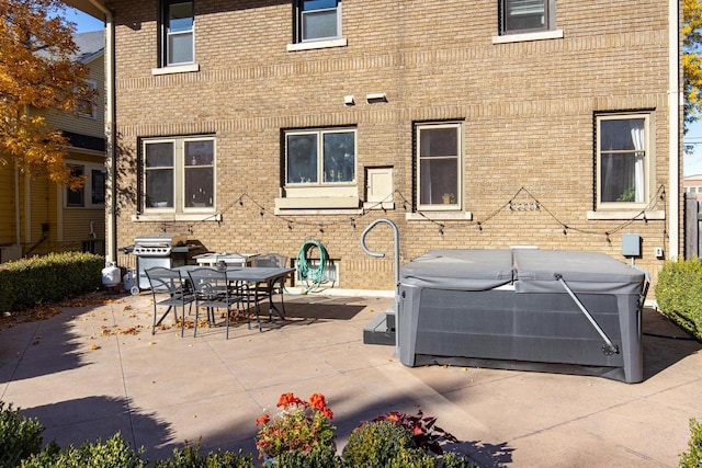 1337 Washington Ave, Oshkosh, WI 54901 - view of patio with grilling area, outdoor dining space, and a hot tub