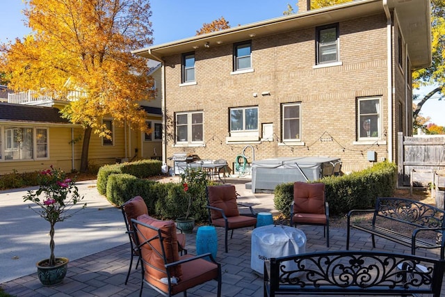 1337 Washington Ave, Oshkosh, WI 54901 - back of house featuring brick siding and a patio