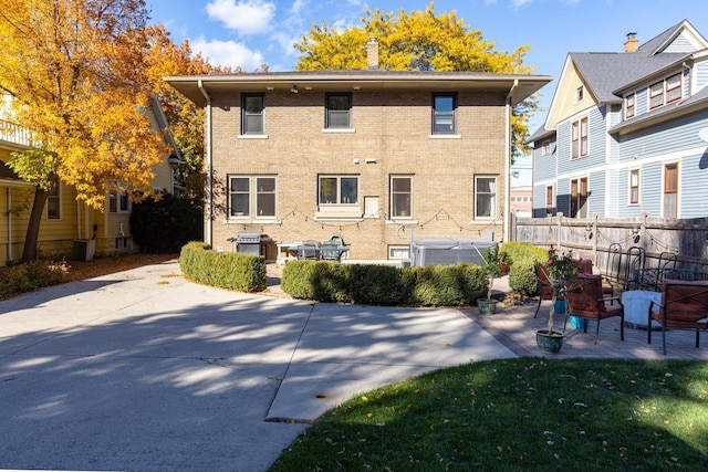 1337 Washington Ave, Oshkosh, WI 54901 - back of property featuring brick siding, central air condition unit, fence, and a patio area