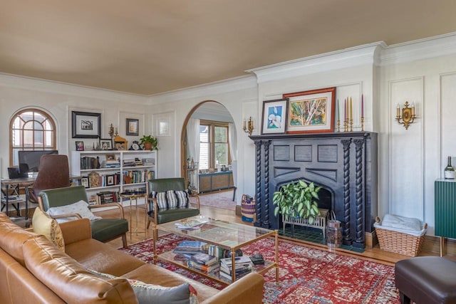 1337 Washington Ave, Oshkosh, WI 54901 - living area with ornamental molding, arched walkways, a fireplace with flush hearth, and wood finished floors