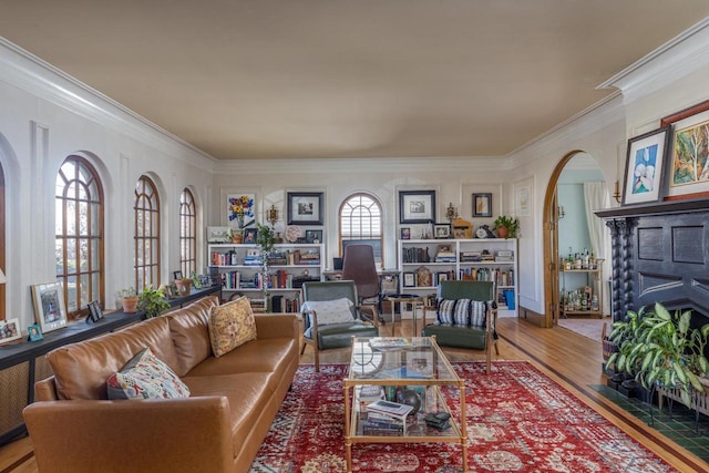 1337 Washington Ave, Oshkosh, WI 54901 - living room with arched walkways, a fireplace with flush hearth, crown molding, and wood finished floors