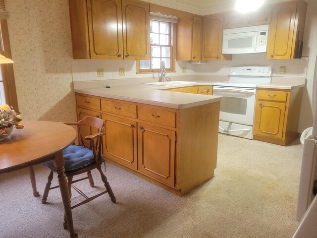 302 Riverview Ct, Portage, WI 53901 - kitchen with light countertops, a sink, a peninsula, white appliances, and wallpapered walls