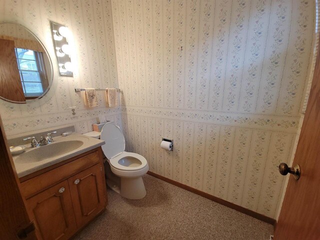 302 Riverview Ct, Portage, WI 53901 - bathroom with wallpapered walls, vanity, toilet, and baseboards