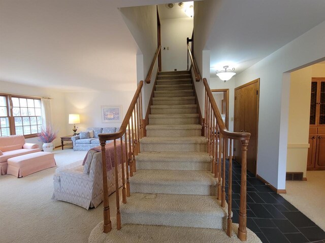302 Riverview Ct, Portage, WI 53901 - staircase featuring baseboards and carpet flooring