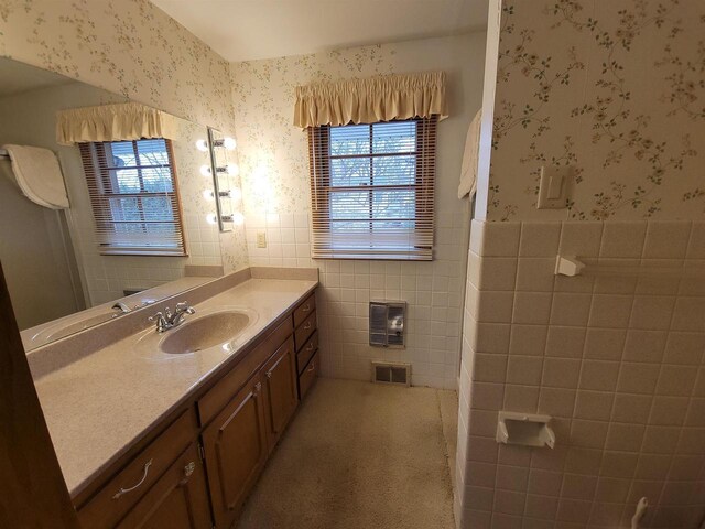 302 Riverview Ct, Portage, WI 53901 - bathroom featuring tile walls, visible vents, wallpapered walls, vanity, and wainscoting