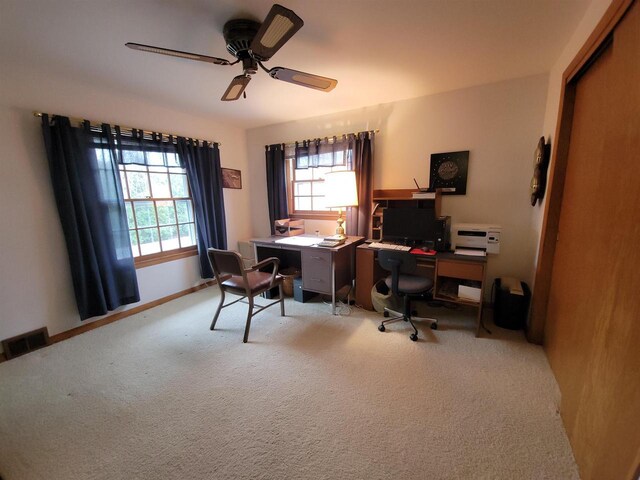 302 Riverview Ct, Portage, WI 53901 - home office featuring a ceiling fan, light carpet, baseboards, and visible vents