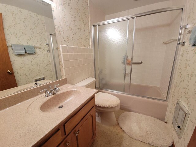 302 Riverview Ct, Portage, WI 53901 - full bathroom featuring vanity, toilet, wallpapered walls, a wainscoted wall, and enclosed tub / shower combo