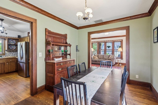 308 Forest St, Mount Horeb, WI 53572 - dining room with hardwood / wood-style floors, baseboards, plenty of natural light, and ornamental molding