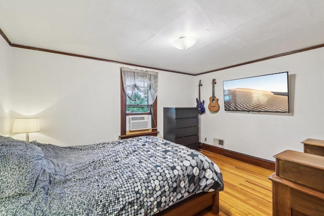 308 Forest St, Mount Horeb, WI 53572 - bedroom with ornamental molding, wood finished floors, cooling unit, and baseboards