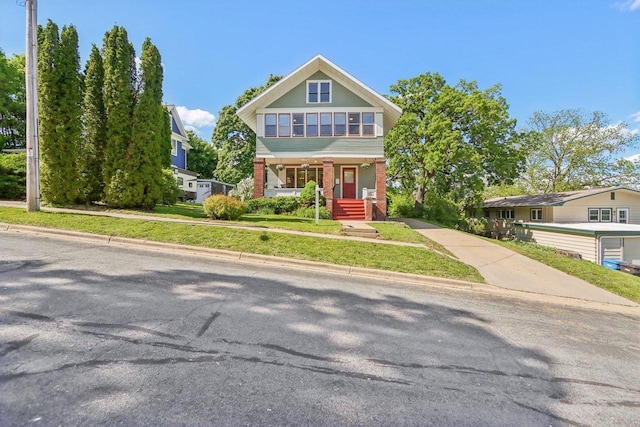 308 Forest St, Mount Horeb, WI 53572 - view of front of home featuring brick siding, a porch, and concrete driveway