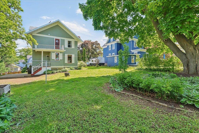 308 Forest St, Mount Horeb, WI 53572 - rear view of property with a balcony and a lawn