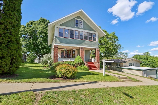 308 Forest St, Mount Horeb, WI 53572 - view of front of property featuring brick siding, a porch, and a front lawn