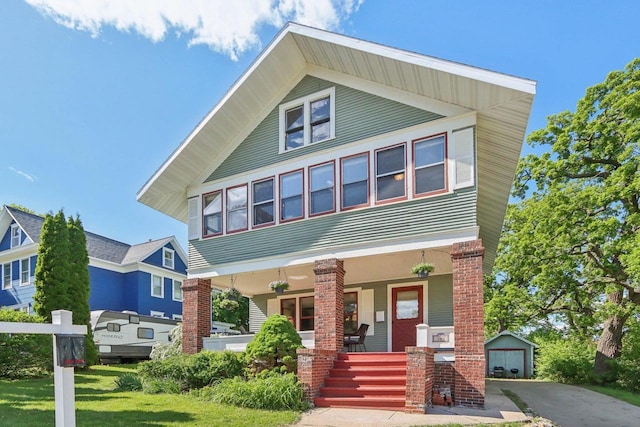 308 Forest St, Mount Horeb, WI 53572 - view of front of home featuring covered porch, an outbuilding, a garage, and driveway