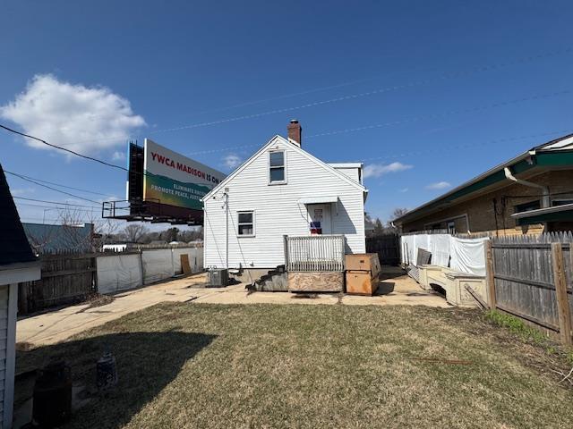 4273 W Beltline Hwy, Madison, WI 53711 - back of house featuring a chimney, central AC, a yard, and a fenced backyard